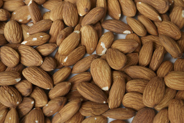 Vegan food. Raw Almond nuts for roasting closeup. Natural food background.