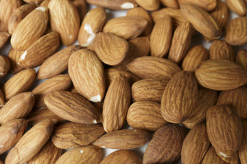 Vegan food. Raw Almond nuts for roasting closeup. Natural food background.
