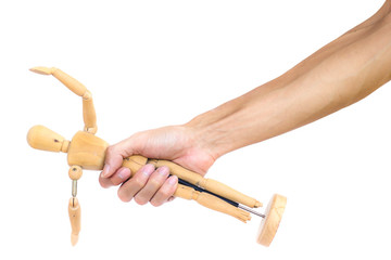 A man hand holding wooden puppet isolated on white background. Hand hold wooden human puppet. human wood puppet in man hand. A wooden figure in the hand. Clipping path on white background.