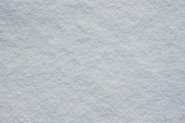 Texture of fresh snow covering ground thickly on frosty winter morning outside. View from above. Horizontal color photography.