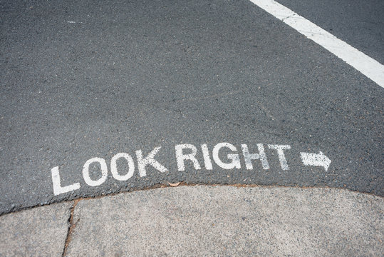 sign on road in Sydney reminding pedestrains to look right for oncoming traffic
