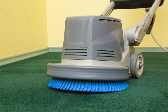 Carpet chemical foaming, rubbing and cleaning with professionally disk machine. Early spring regular cleanup. Commercial cleaning company concept.