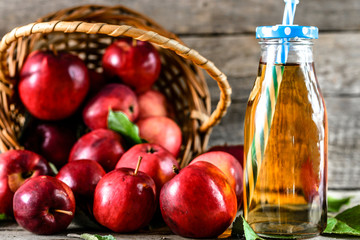 Red apple juice on table, healthy detox drink with vitamins, organic food concept