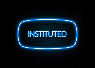 Instituted  - colorful Neon Sign on brickwall