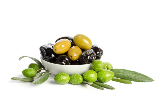 Black and green  olives  mixed in the  porcelain bowl isolated on white background