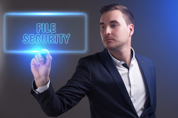 The concept of business, technology, the Internet and the network. Young businessman showing inscription: File security