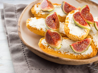 Crostini with cheese and figs. Light sweet and savory snack with wine