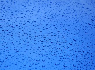 Water droplets on blue surface