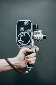 Woman hand holding old film camera