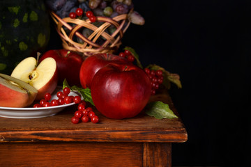 Red ripe apples on a wooden surface.