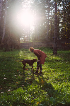 Girl playing with dog