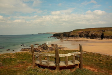 Bench overlooking beach Cornwall England