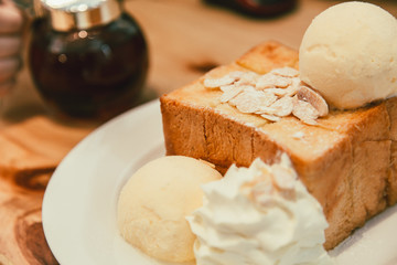 Honey toast with Icecream delicious tasty bread sweet dessert on wood table vintage color tone