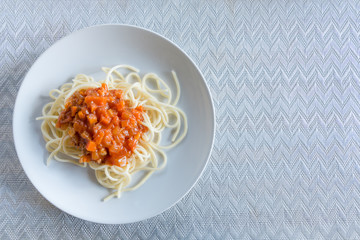 Spaghetti with tomato sauce in a white dish for breakfast.