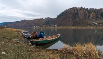 Fishing boats on the autumn river in the countryside