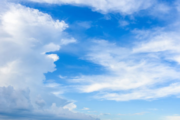 Naklejka na ściany i meble White textured clouds in the blue sky.