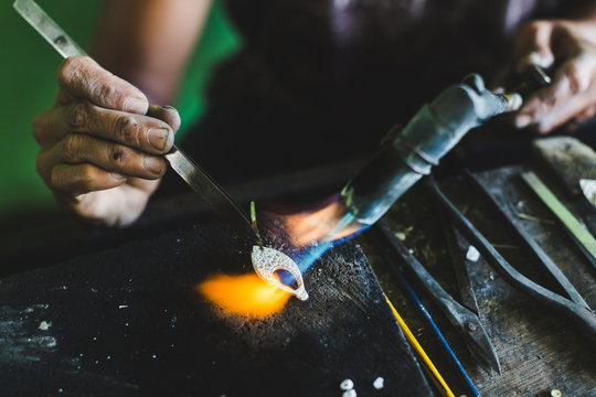 Woman making silver jewelry