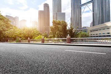 empty asphalt road and modern buildings in midtown of modern city