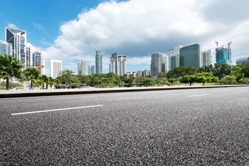 empty asphalt road and modern buildings in midtown of modern city