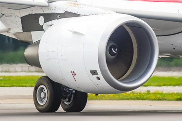 Large modern aircraft view of the huge engine and chassis, the light of the sun.