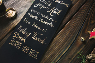 Christmas message written in different languages with golden letters