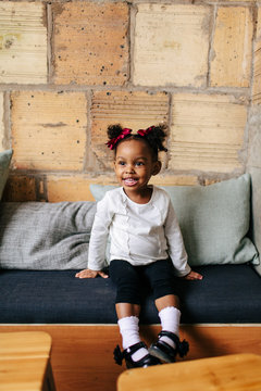 Natural light portrait of a 2 year old girl with pig tails