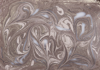 Liquid gold marbled pattern. Beige background