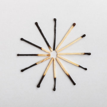 Matches forming clock on slightly gray background