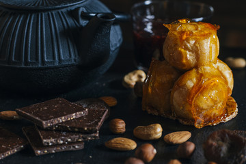 Cream puff cake with caramel icing and pieces of dark chocolate. Traditional french and Italian pastry. Delicious dessert. Toned