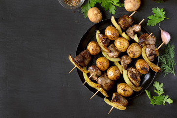 Chicken liver, potato and bell pepper on skewers