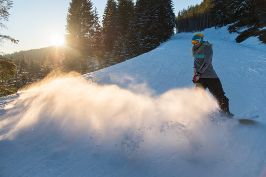 Full length shot of a woman snowboarder riding snowy slope copyspace scenery nature evening mountains powder freeride snowboarding copyspace