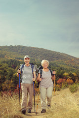 Fototapeta na wymiar Two elderly hikers walking outside