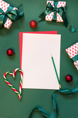 Christmas red blank for letter to Santa on green.