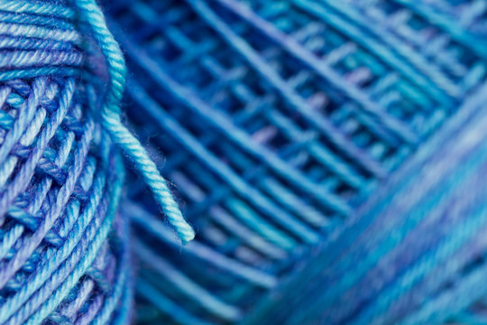 Macro of variegated blue spool of yarn