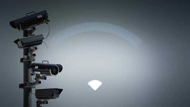 The signal of an active Wifi appearing over a row of surveillance security cams in a public street, watching the neighbors.
