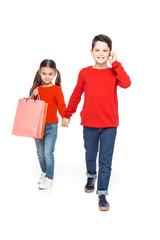 siblings with shopping bags