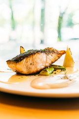 Salmon fillet meat steak with sauce in white plate