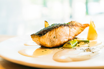 Salmon fillet meat steak with sauce in white plate