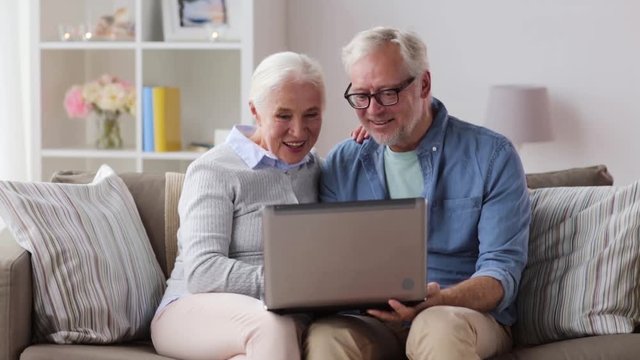 senior couple having video chat on laptop at home
