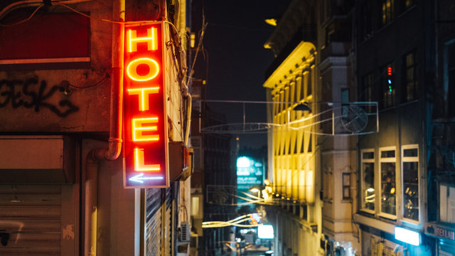 Hotel neon sign pointing left