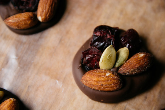 Home made chocolate with cranberry, almonds and pumpkin seeds
