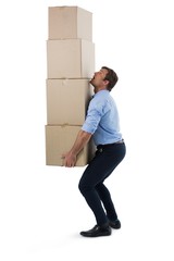 Male executive carrying stack of cardboard boxes