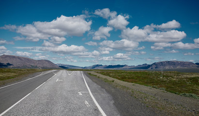 Travel to Iceland. plot of asphalt road in a bright sunny mountain landscape. Thingvellir National Park