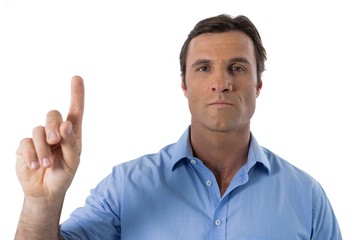 Male executive pressing an invisible virtual screen