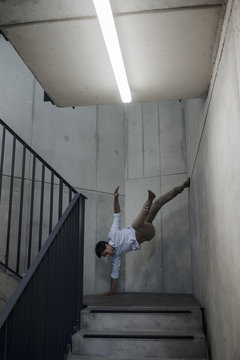 Young man balancing in staircase