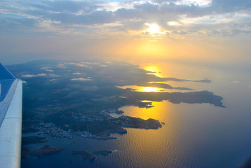 Spanish island Menorca shot from airplane leaving island at evening.