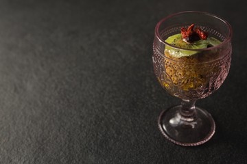 Dried fruits and granola bar in glass