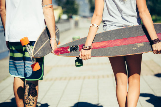 Skaters holding their longboards