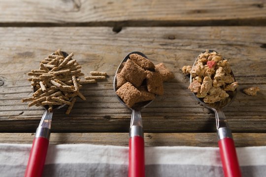 Three spoons with various breakfast cereals - Powered by Adobe