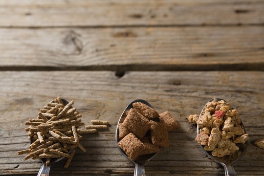 Three spoons with various breakfast cereals
